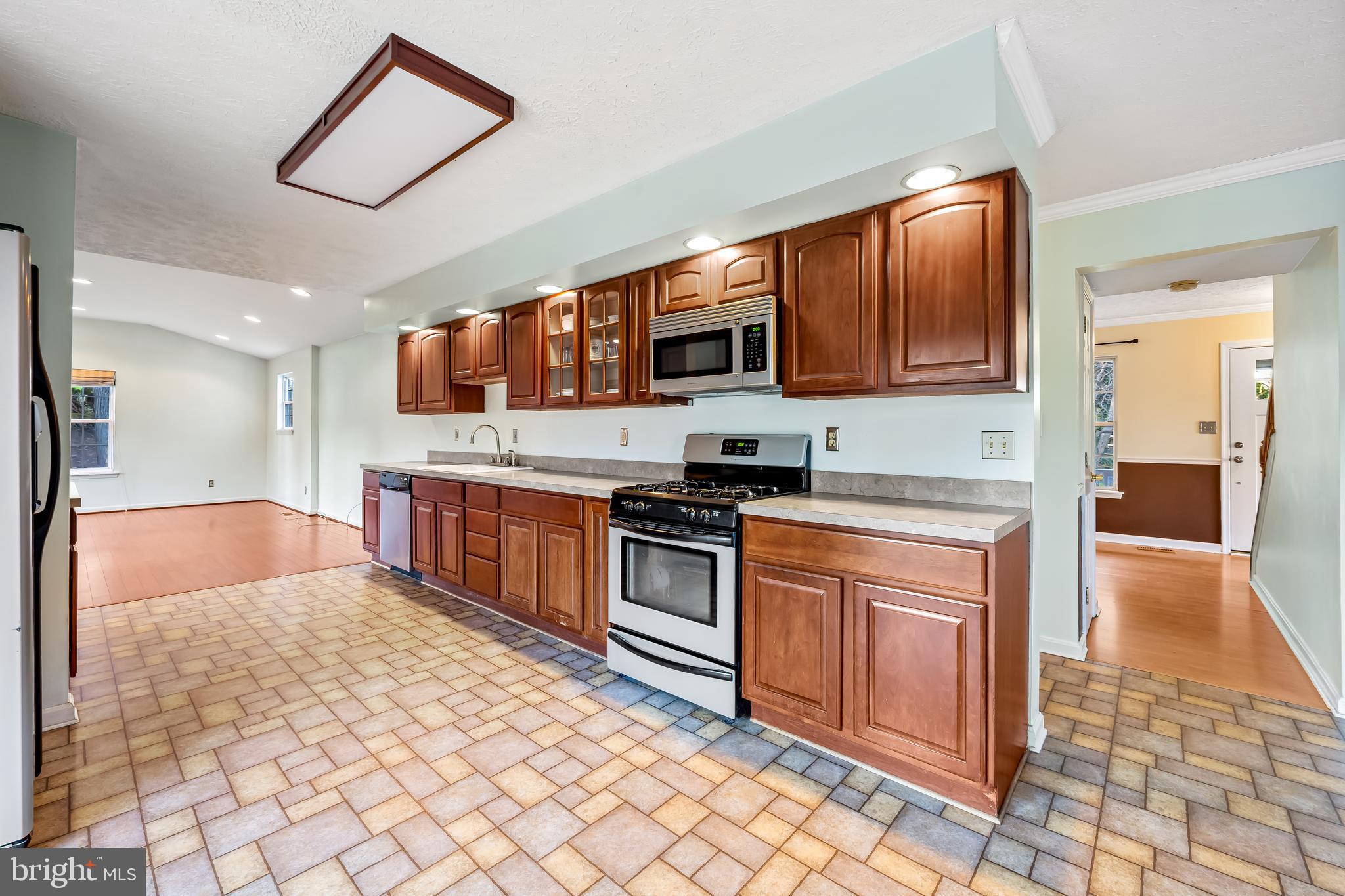 2807 Emmorton Road Abingdon, MD 21009 - Photo 13 of 36 a kitchen with stainless steel appliances granite countertop a stove top oven a sink a counter top space and cabinets