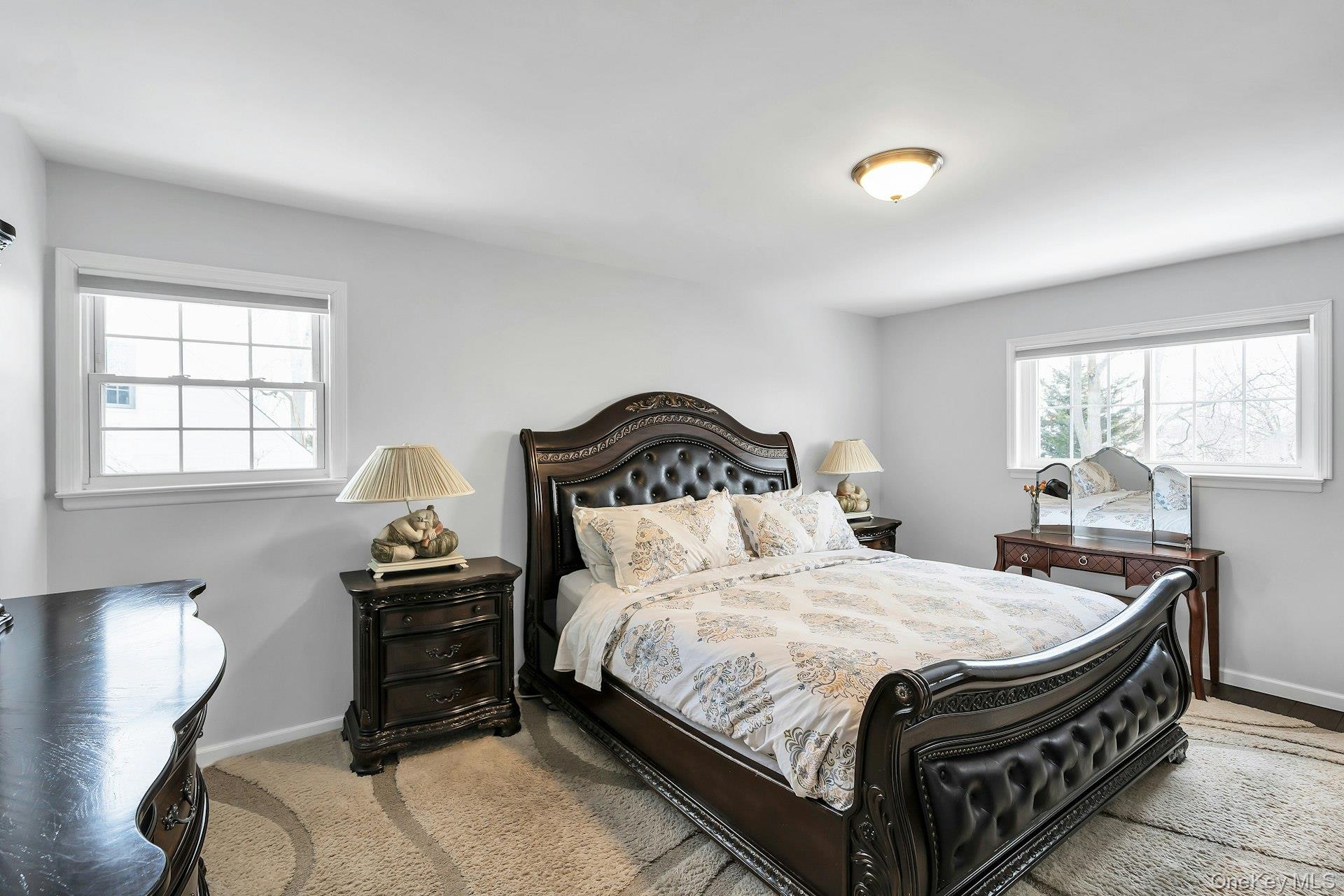 2043 Ripley Lane Merrick, NY 11566 - Photo 22 of 42 a bedroom with a bed and window with lamp