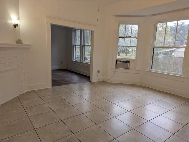 an empty room with windows and closet