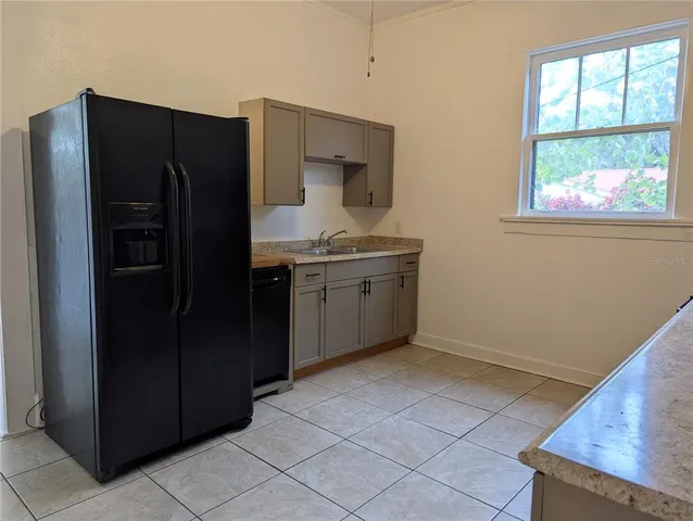 a kitchen with a refrigerator and window