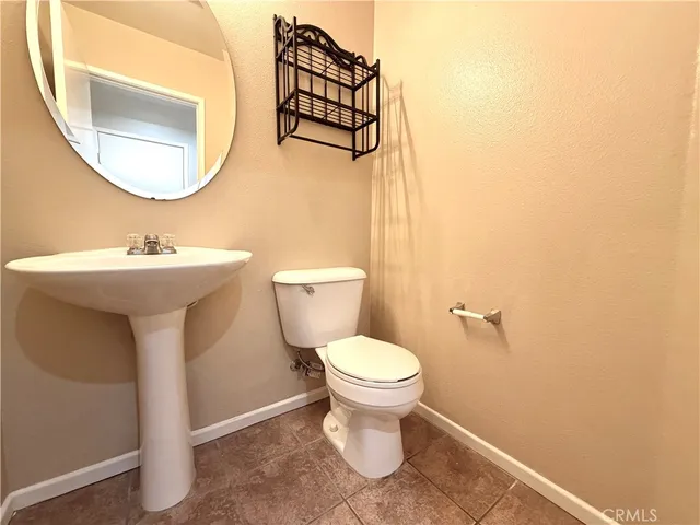 a bathroom with a sink toilet and mirror