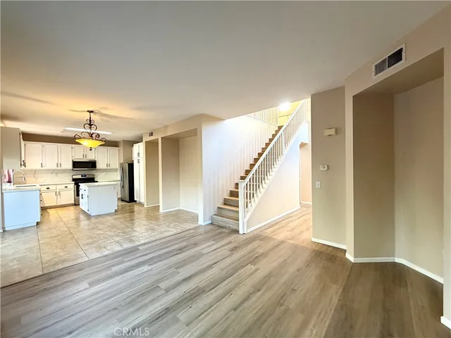 a view of kitchen and hall with wooden floor