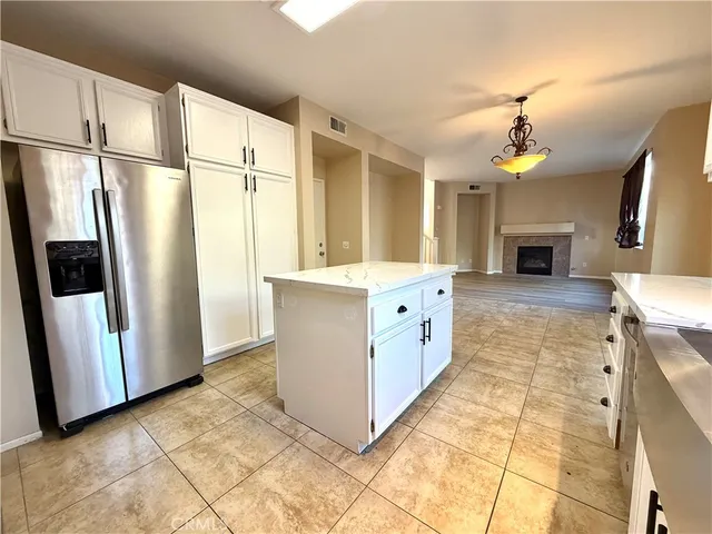 a view of living room with furniture and a fireplace