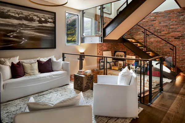 a living room with furniture and a painting on the wall