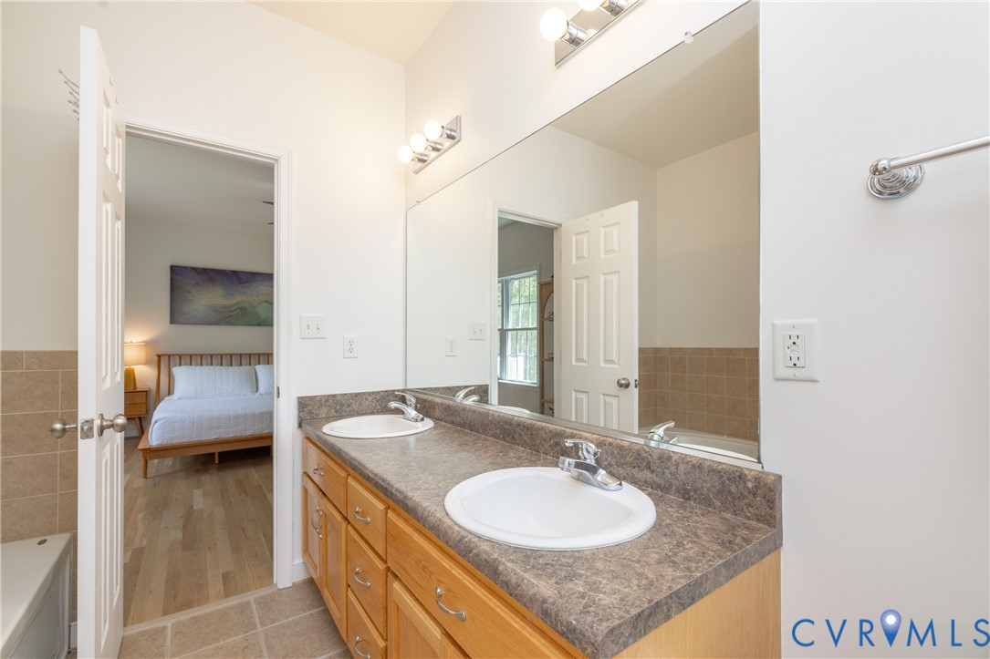15618 Rowlett Road Chesterfield, VA 23838 - Photo 8 of 29 a en suite bathroom with a granite countertop sink and a mirror