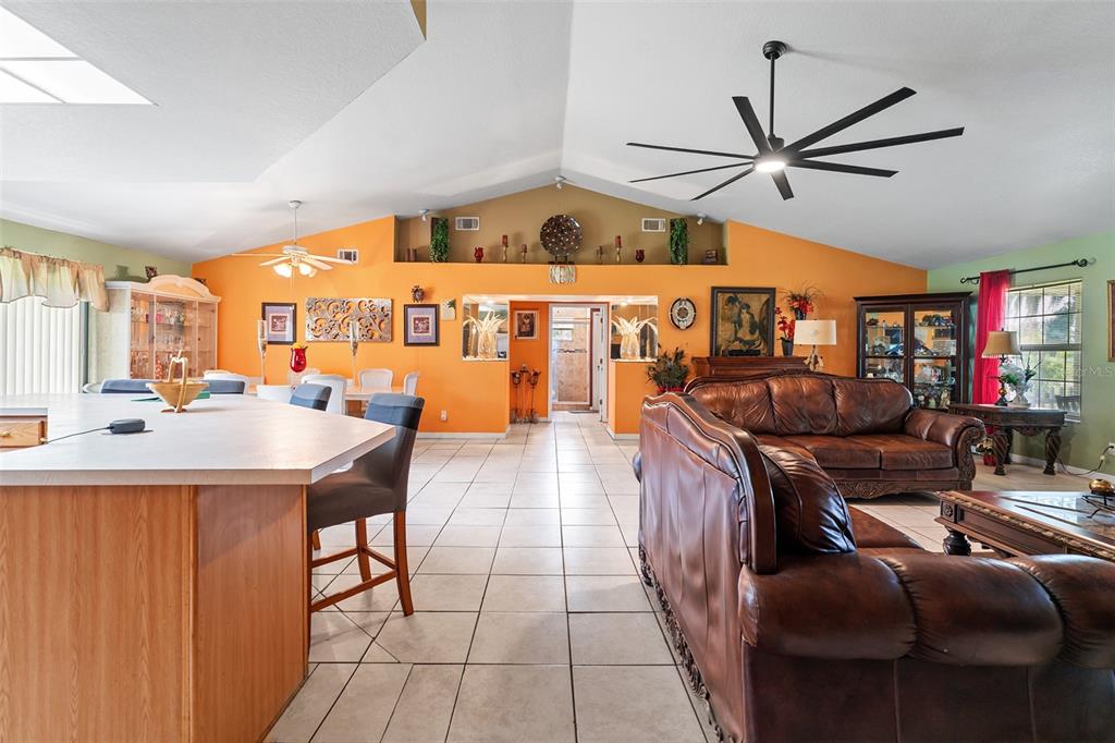 2830 Horton Road Kissimmee, FL 34744 - Photo 11 of 35 a dining hall with stainless steel appliances kitchen island granite countertop a table chairs and a refrigerator