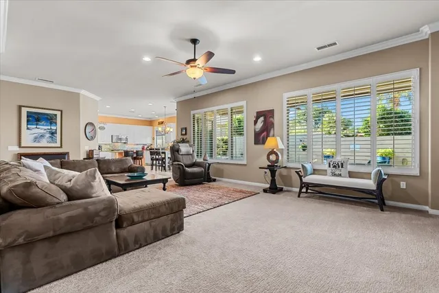 a living room with furniture and a dining table with projector the view