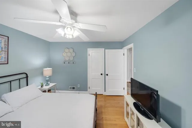 a bed room with a large bed and a chandelier
