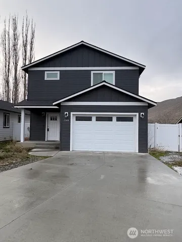 a front view of a house with garage and parking space