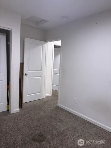an empty room with closet area