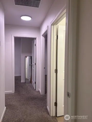 a view of a room with wooden floor and sliding door