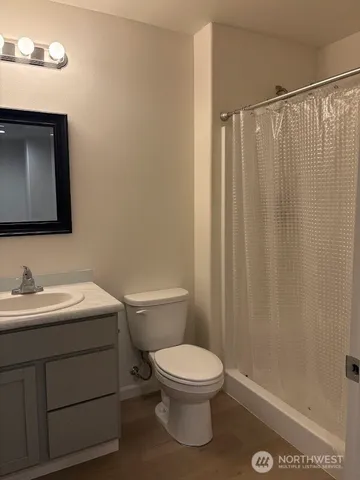 a bathroom with a toilet a sink and a mirror