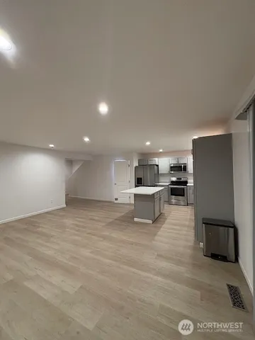 a view of kitchen with furniture and refrigerator