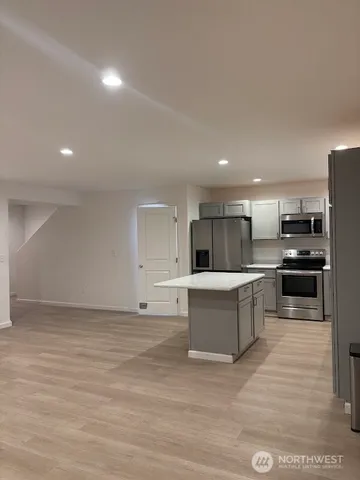 a large white kitchen with cabinets