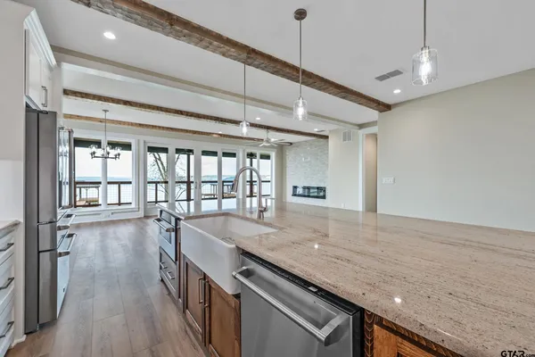 a kitchen with refrigerator cabinets and wooden floor