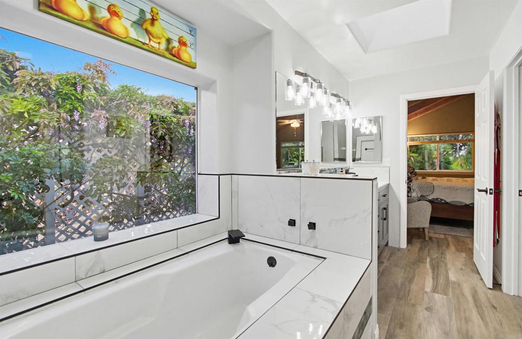 2092 Tudor Lane Fallbrook, CA 92028 - Photo 16 of 52 a view of a bedroom with wooden floor and a window