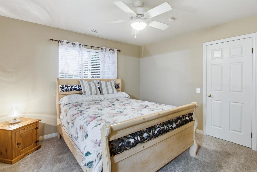 2092 Tudor Lane Fallbrook, CA 92028 - Photo 21 of 52 a bedroom with a bed and a chandelier