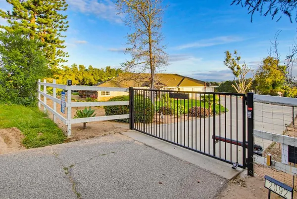 a view of a backyard with a wooden fence