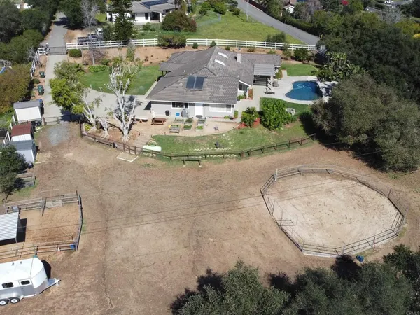 an aerial view of a house with a yard