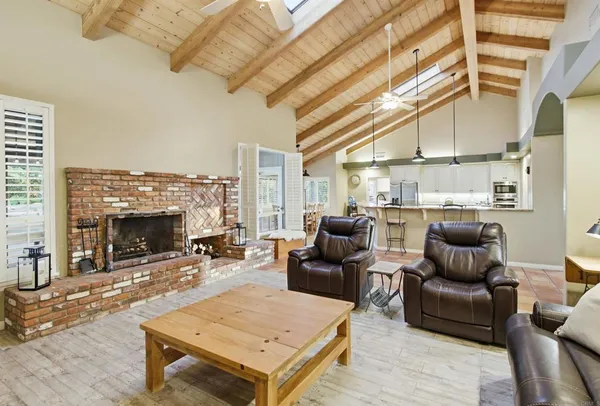 a living room with furniture a fireplace and a table