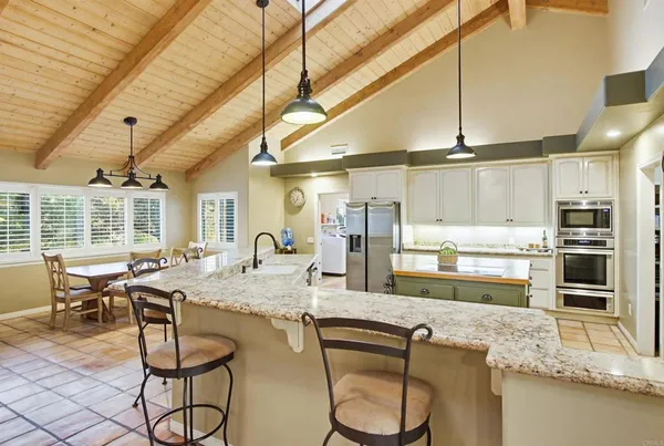 a kitchen with stainless steel appliances granite countertop a sink and cabinets