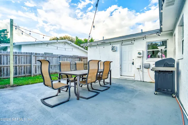 a view of a patio with a table and chairs