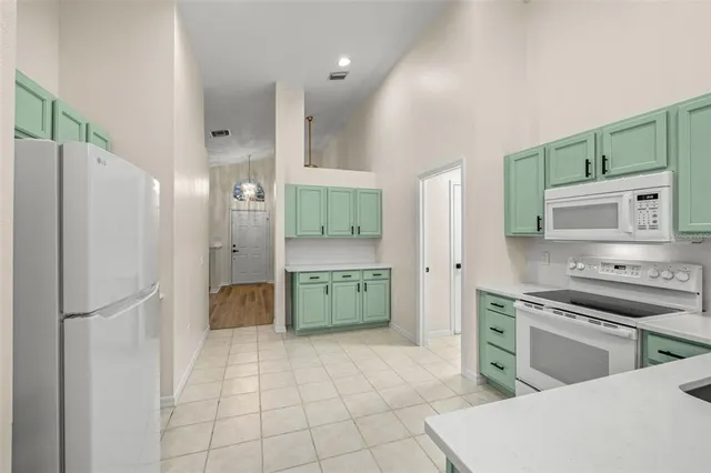 a kitchen with stainless steel appliances a refrigerator sink and stove