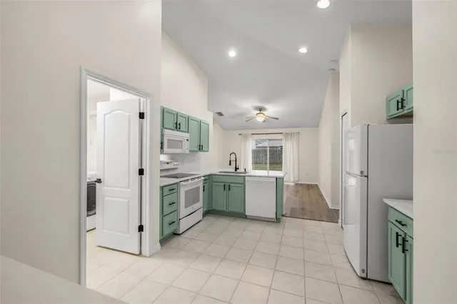 a kitchen with a sink stove and refrigerator