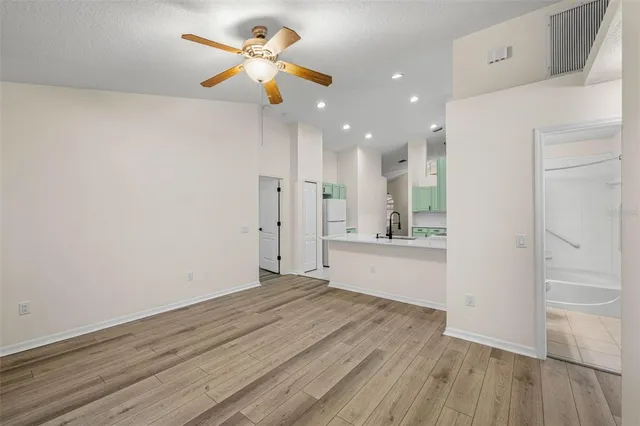 a view of an empty room and window with wooden floor
