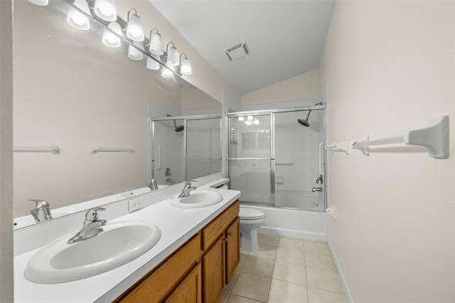 a bathroom with a double vanity sink mirror double and shower