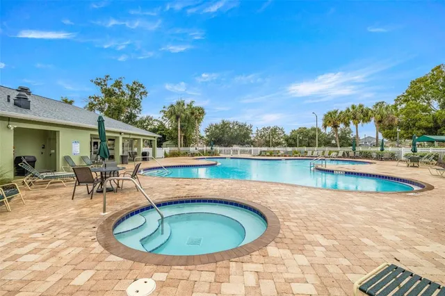 a view of a swimming pool with a patio
