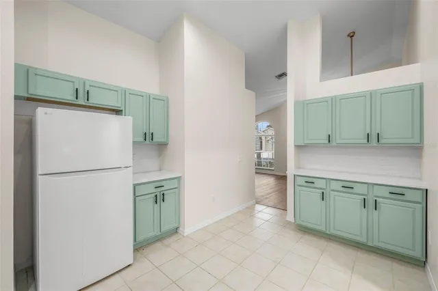 a kitchen with a refrigerator and a sink