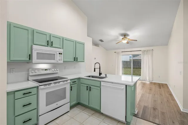 a kitchen with a sink stove and microwave