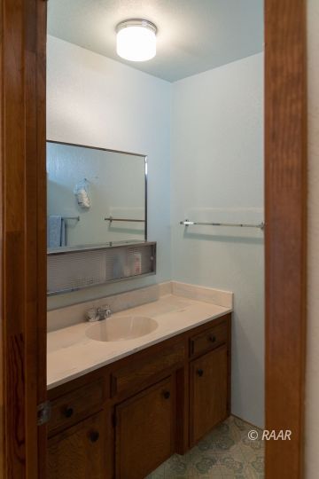 2109 West Ridgecrest Boulevard Ridgecrest, CA 93555 - Photo 22 of 35 a bathroom with a sink and a mirror