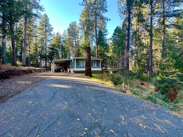 a view of a house with swimming pool and sitting area