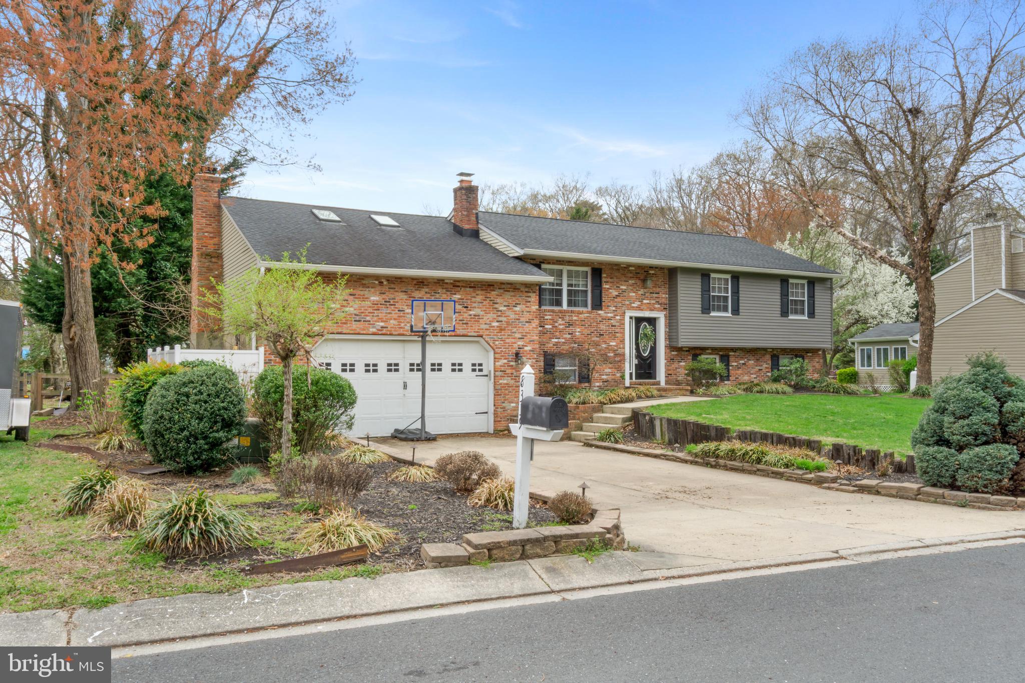 a front view of a house with a yard and potted plants