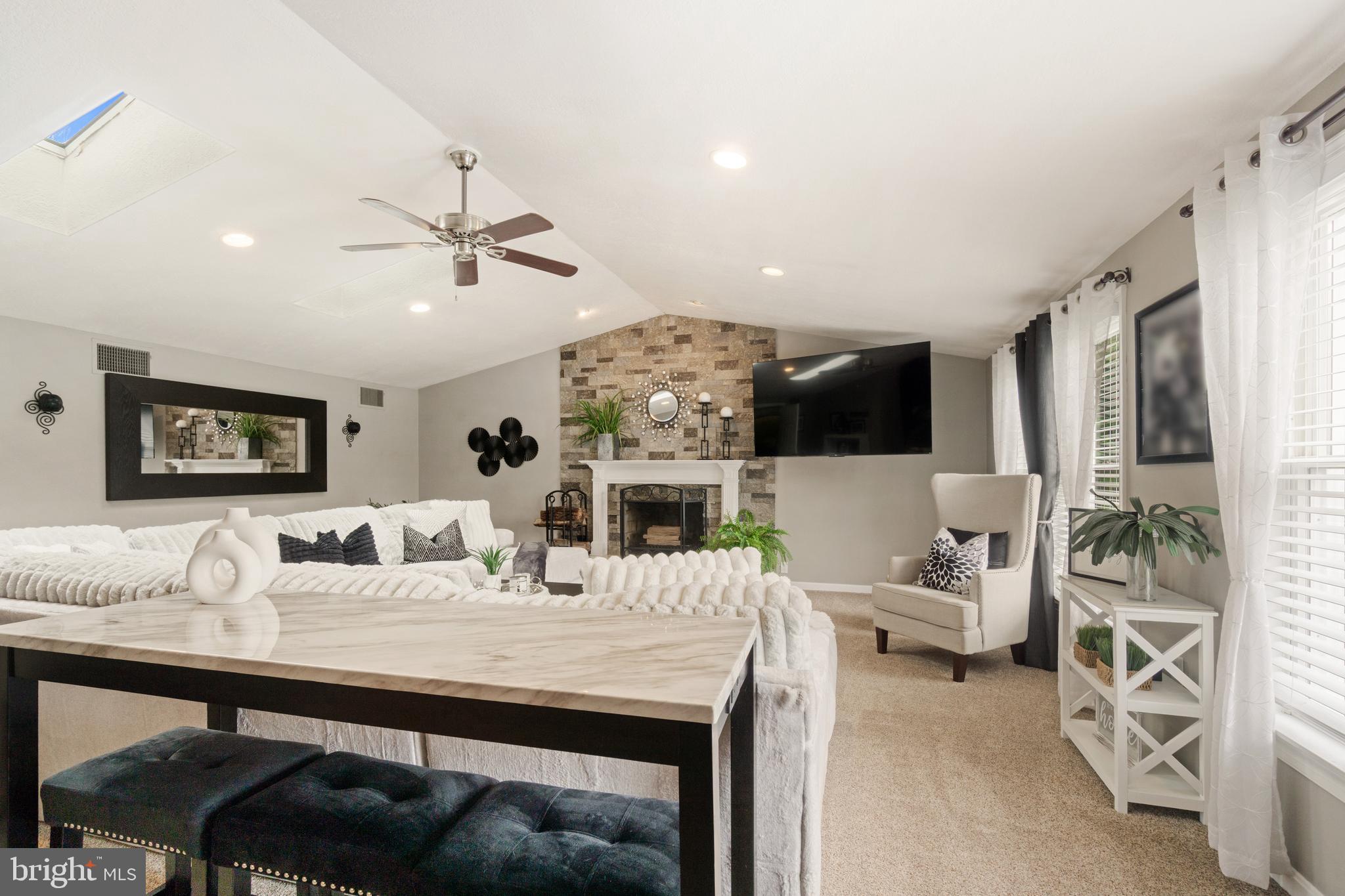 8339 Capel Drive Pasadena, MD 21122 - Photo 15 of 51 a view of a dining room with furniture and a fireplace