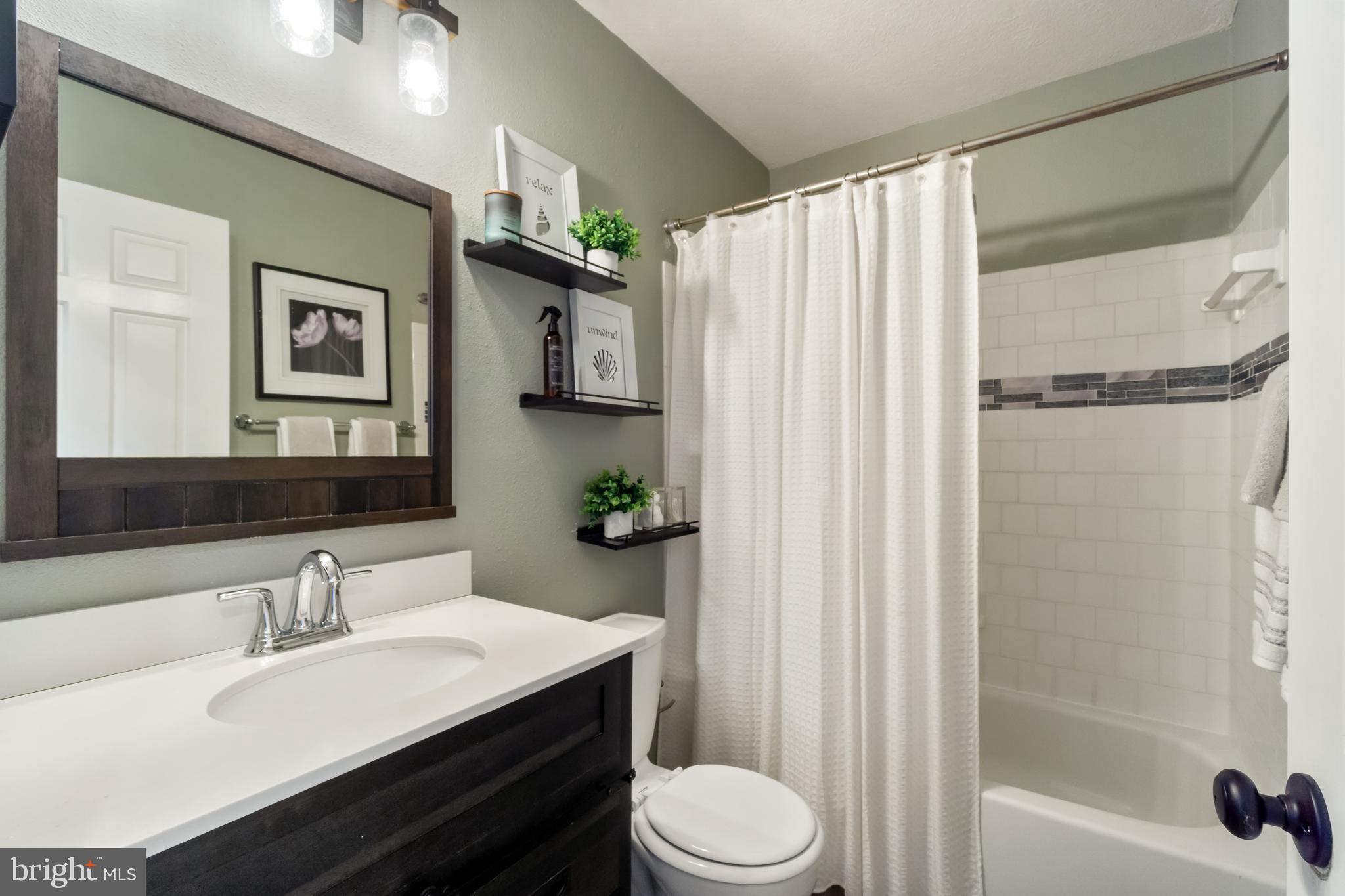 8339 Capel Drive Pasadena, MD 21122 - Photo 21 of 51 a bathroom with a sink a toilet and shower