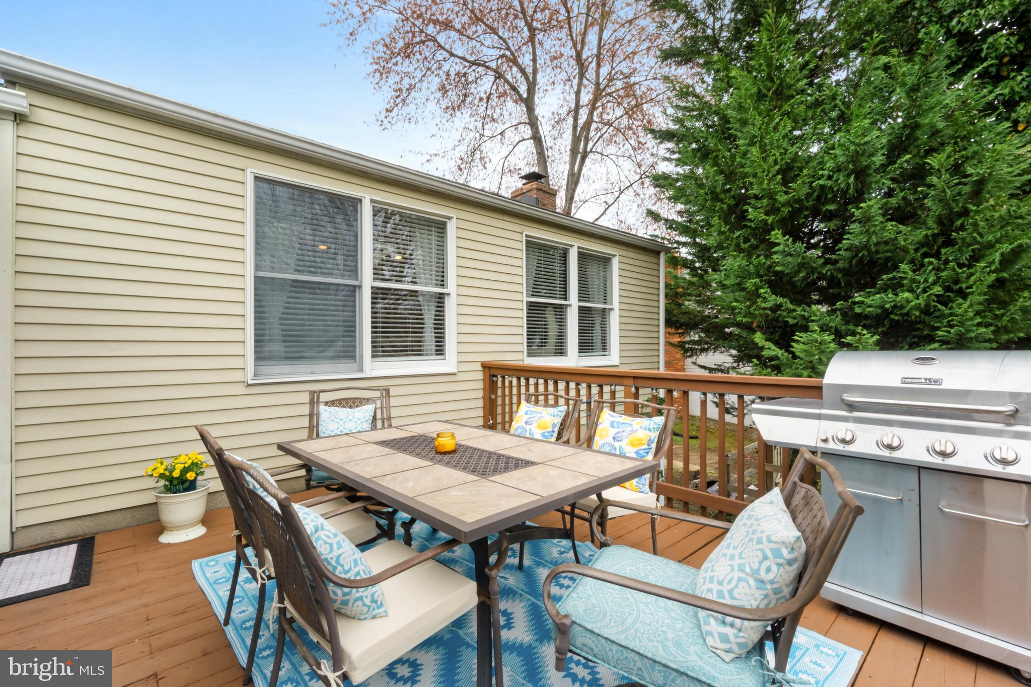8339 Capel Drive Pasadena, MD 21122 - Photo 25 of 51 a view of a patio with table and chairs with wooden floor and fence