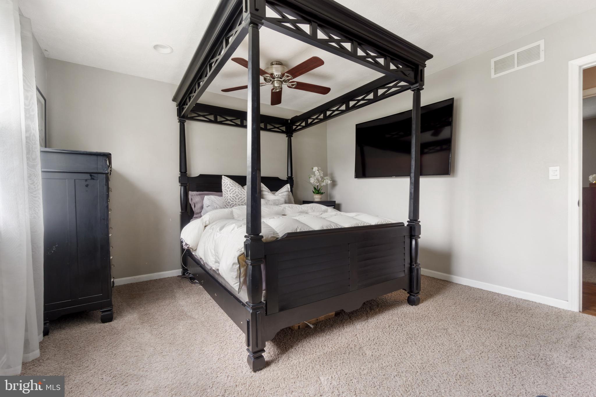 8339 Capel Drive Pasadena, MD 21122 - Photo 29 of 51 a bedroom with a bed a walk in closet and a window