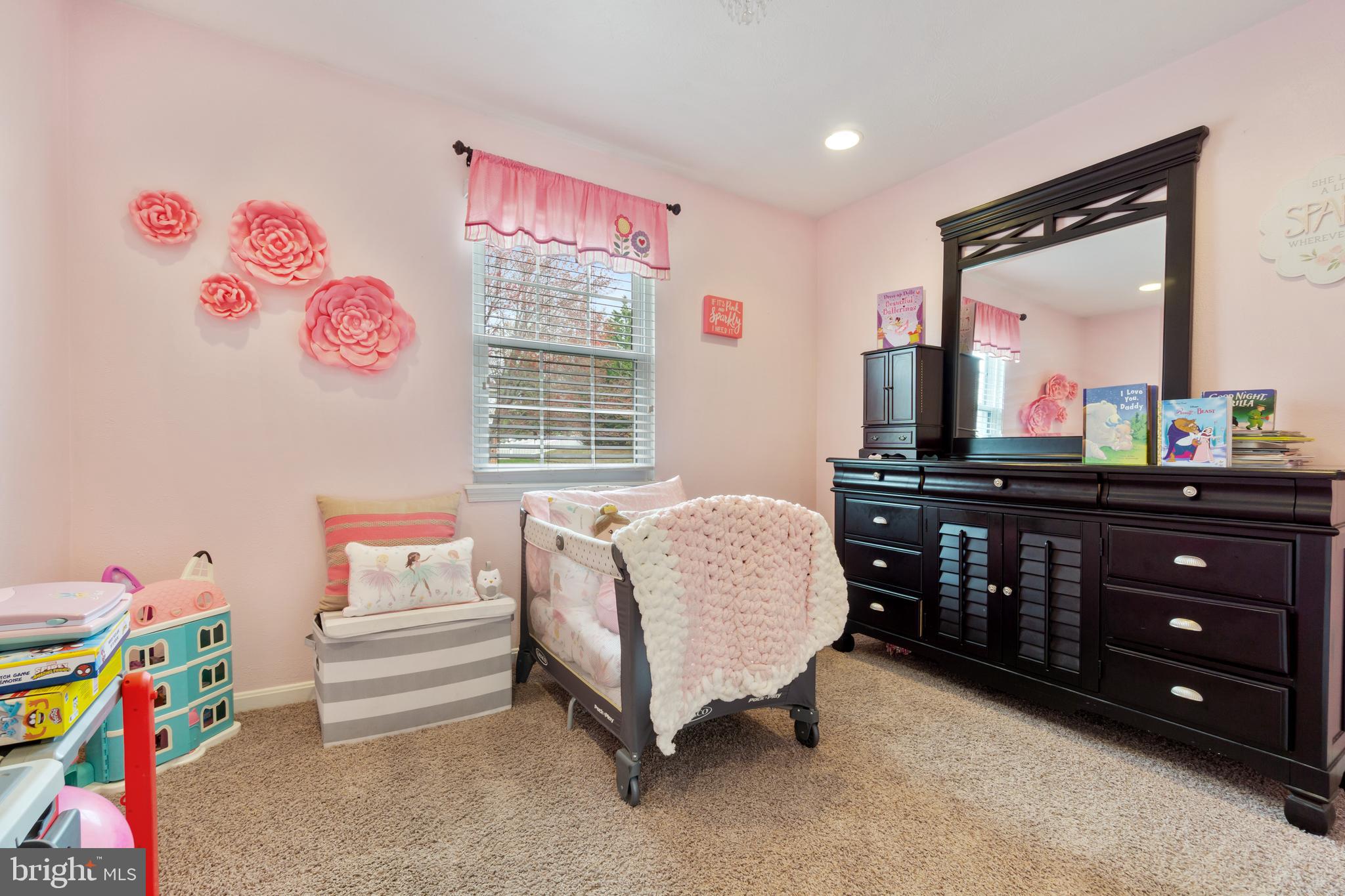8339 Capel Drive Pasadena, MD 21122 - Photo 33 of 51 a living room with furniture a baby crib and a dresser