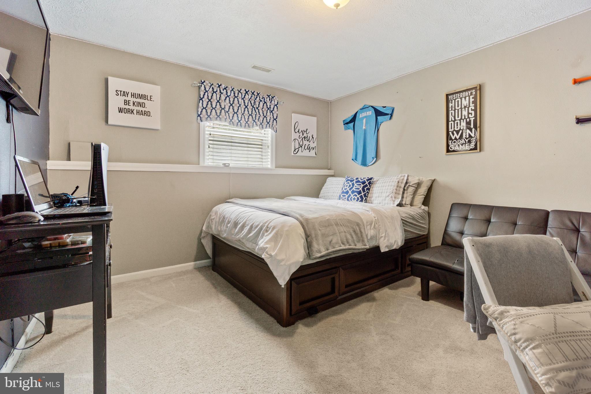 8339 Capel Drive Pasadena, MD 21122 - Photo 35 of 51 a bedroom with a bed and a night stand