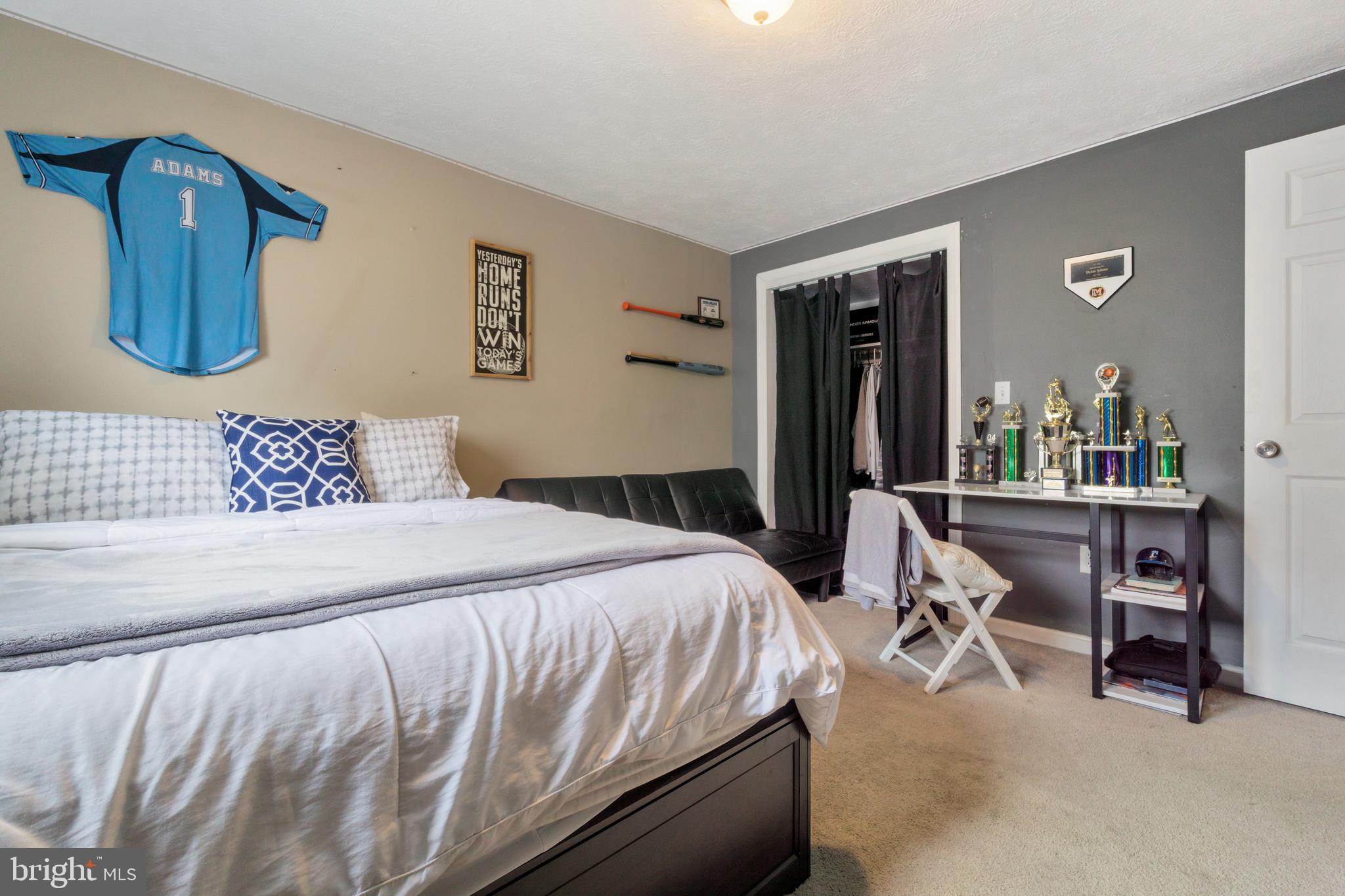 8339 Capel Drive Pasadena, MD 21122 - Photo 36 of 51 a bedroom with a bed and dresser with mirror