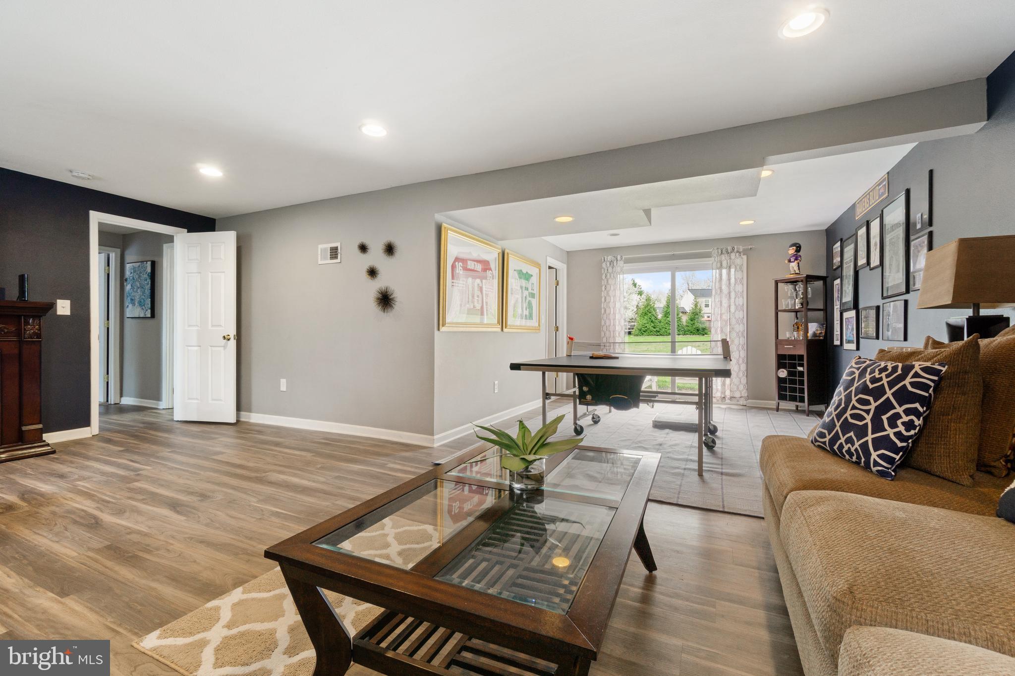 8339 Capel Drive Pasadena, MD 21122 - Photo 38 of 51 a living room with furniture and wooden floor