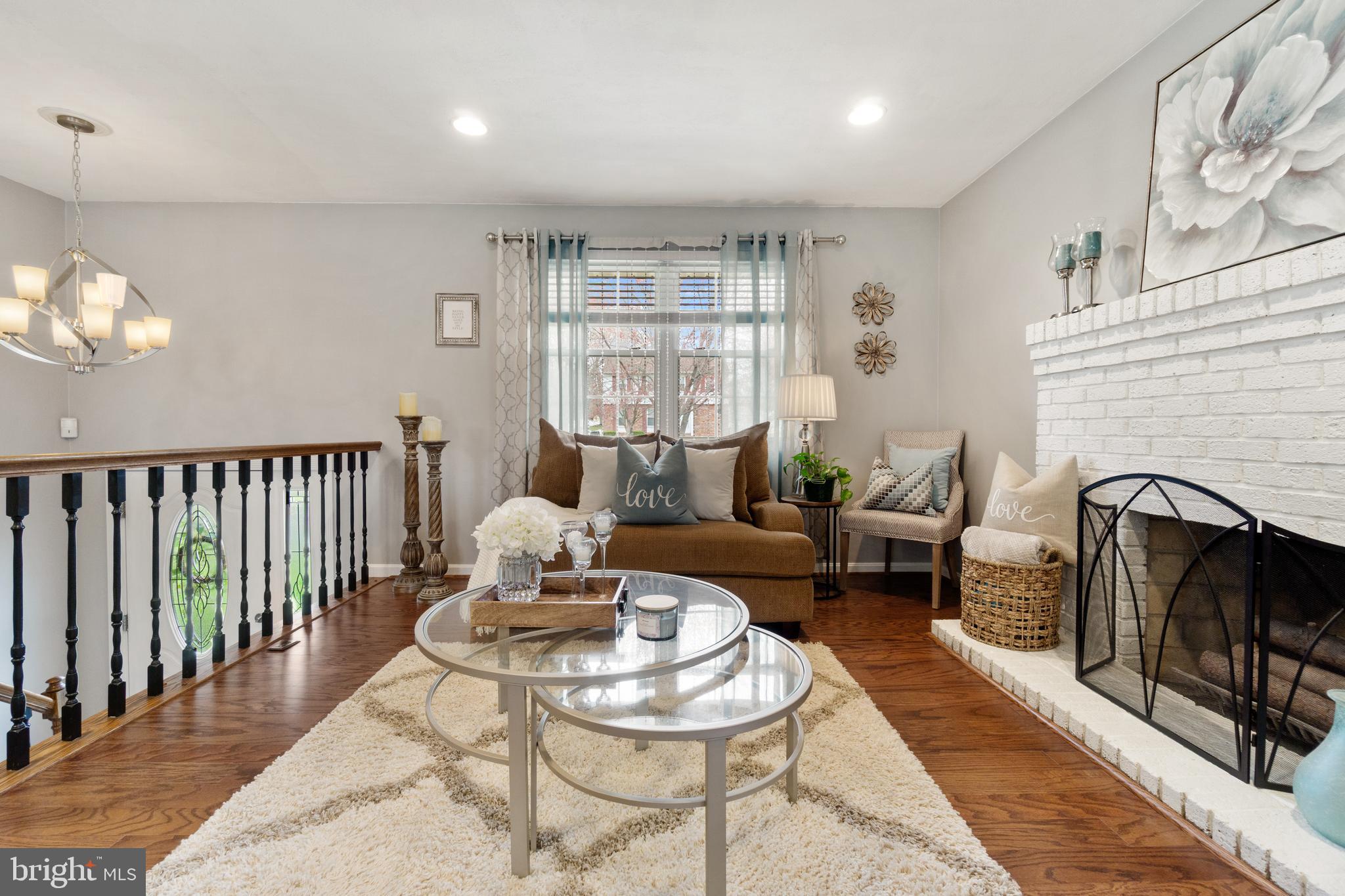 8339 Capel Drive Pasadena, MD 21122 - Photo 8 of 51 a living room with furniture and a fireplace