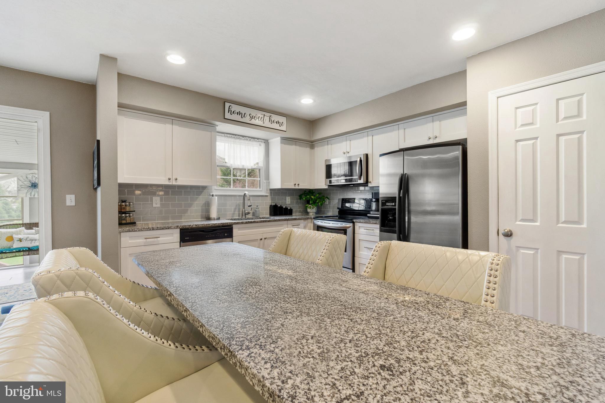 8339 Capel Drive Pasadena, MD 21122 - Photo 9 of 51 a large kitchen with kitchen island a sink stainless steel appliances and cabinets