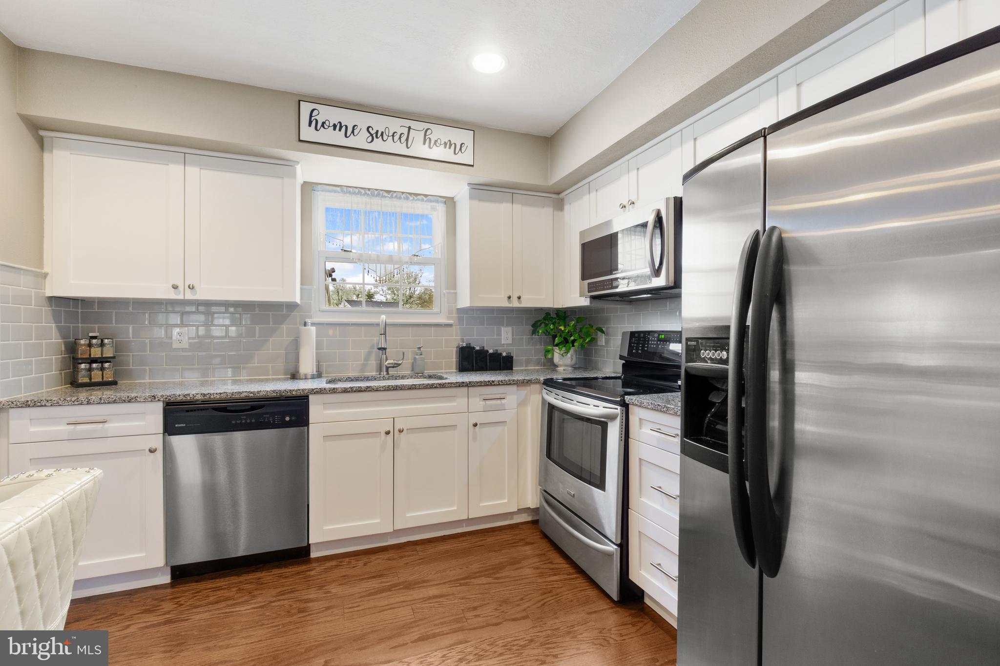 8339 Capel Drive Pasadena, MD 21122 - Photo 10 of 51 a kitchen with stainless steel appliances granite countertop a stove a sink and a refrigerator