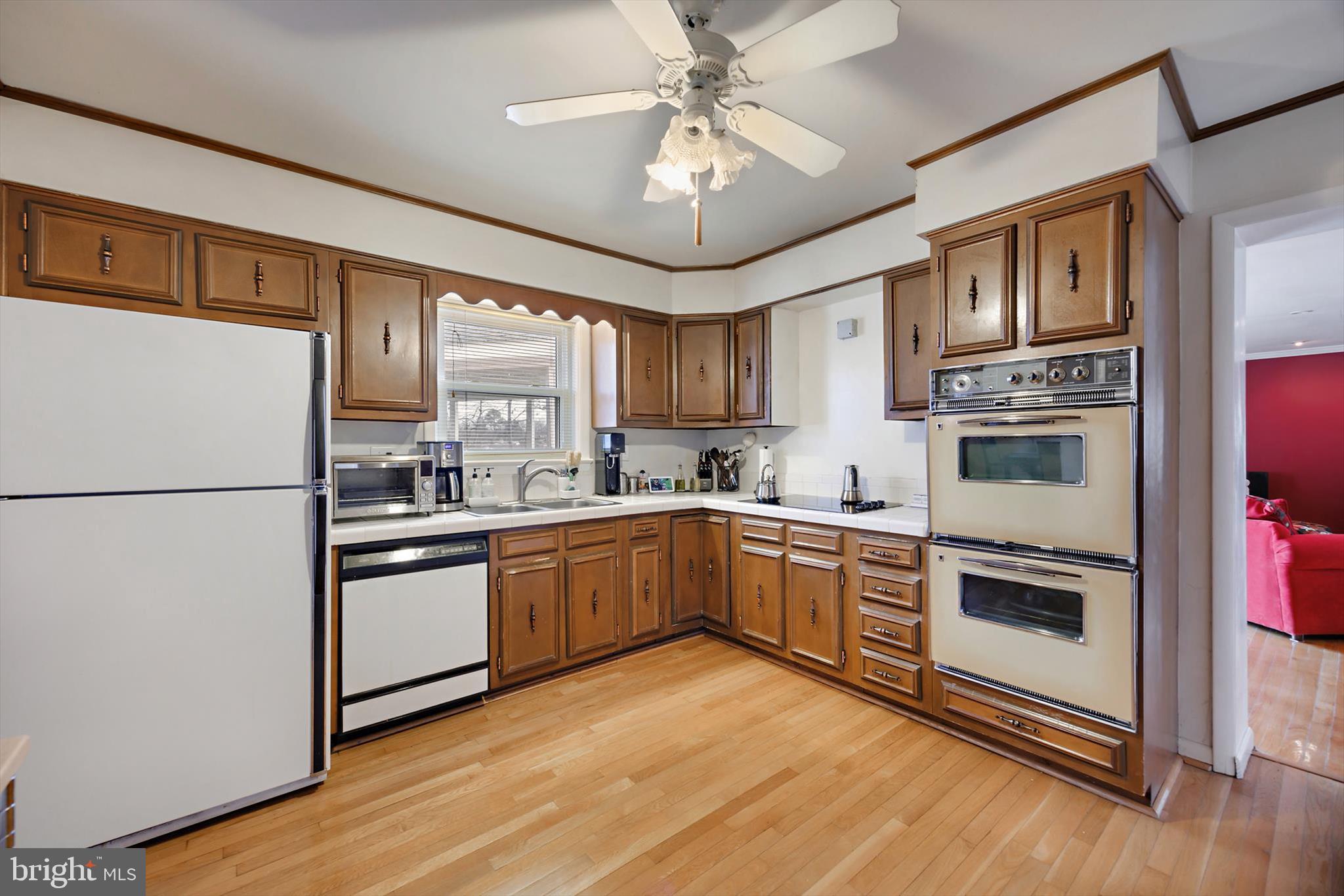 11406 Accolade Terrace Clinton, MD 20735 - Photo 11 of 45 a kitchen with stainless steel appliances granite countertop a refrigerator a stove a sink dishwasher and a refrigerator with wooden floor