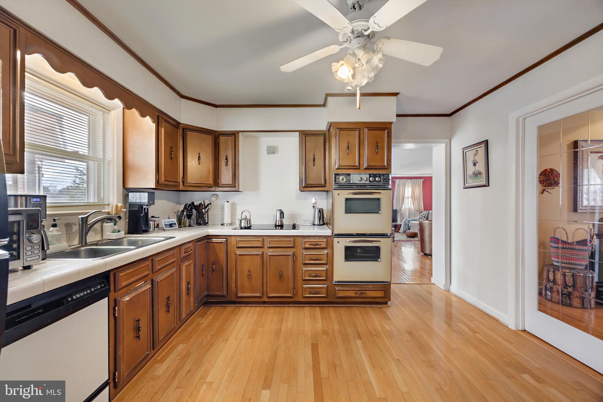 11406 Accolade Terrace Clinton, MD 20735 - Photo 12 of 45 a kitchen with stainless steel appliances granite countertop a sink cabinets and wooden floor