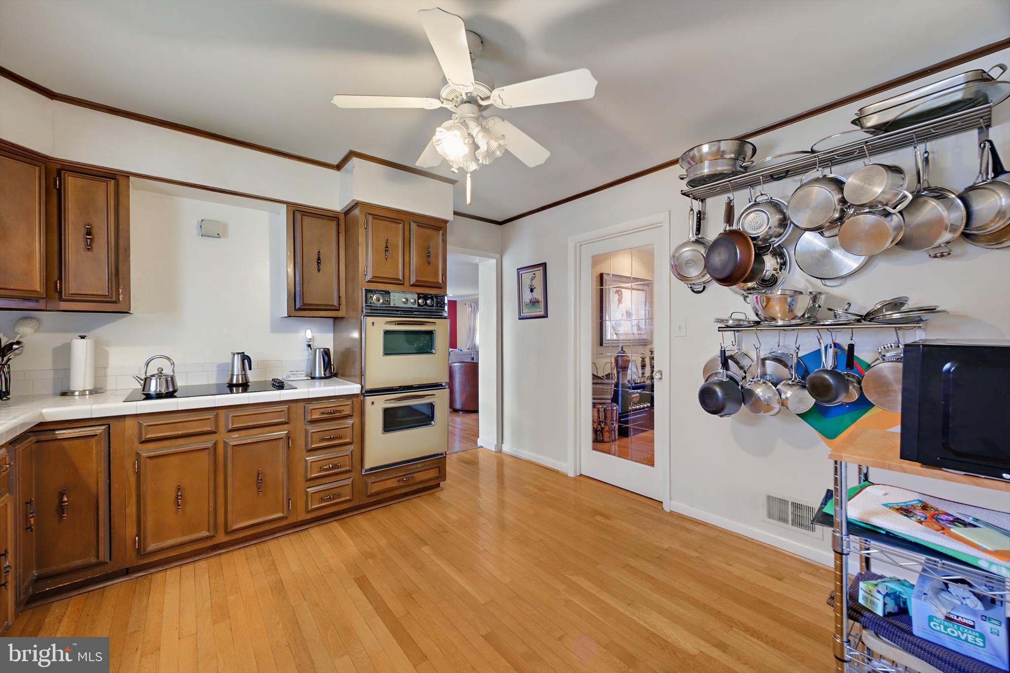 11406 Accolade Terrace Clinton, MD 20735 - Photo 13 of 45 a kitchen with stainless steel appliances granite countertop a sink cabinets and wooden floor